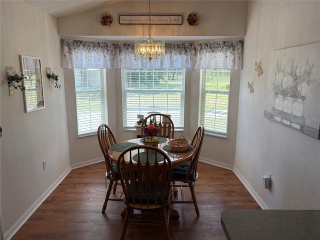 dining space with dark wood finished floors, baseboards, and a notable chandelier