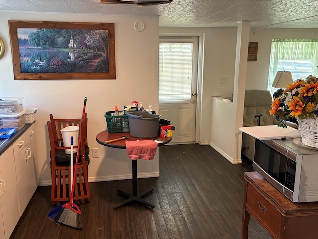 dining room featuring dark wood-type flooring and baseboards