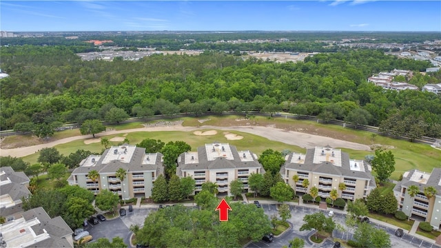 1356 Centre Court Ridge Dr Unit 103, Reunion, FL 34747 - drone / aerial view featuring a wooded view and view of golf course