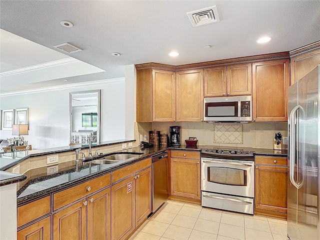 1356 Centre Court Ridge Dr Unit 103, Reunion, FL 34747 - kitchen featuring a sink, dark stone countertops, visible vents, crown molding, and appliances with stainless steel finishes