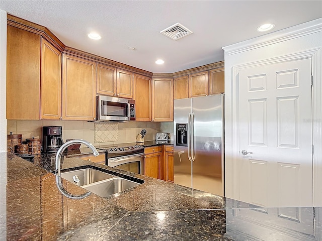 1356 Centre Court Ridge Dr Unit 103, Reunion, FL 34747 - kitchen with stainless steel appliances, visible vents, a sink, and brown cabinets
