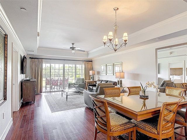 1356 Centre Court Ridge Dr Unit 103, Reunion, FL 34747 - dining space with dark wood finished floors, crown molding, ceiling fan with notable chandelier, and a raised ceiling