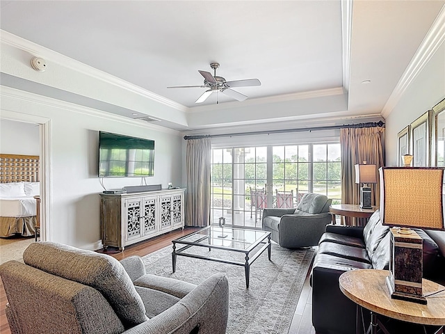 1356 Centre Court Ridge Dr Unit 103, Reunion, FL 34747 - living area featuring ornamental molding, a ceiling fan, wood finished floors, and a raised ceiling