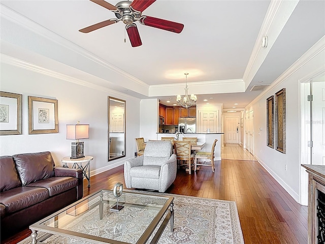 1356 Centre Court Ridge Dr Unit 103, Reunion, FL 34747 - living area featuring ceiling fan with notable chandelier, a raised ceiling, wood-type flooring, baseboards, and visible vents