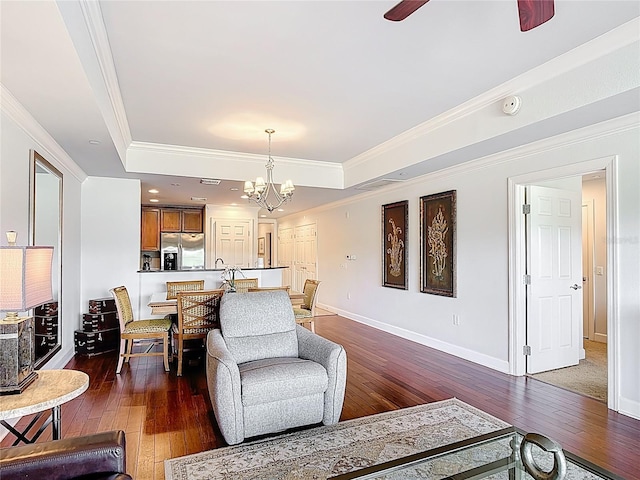 1356 Centre Court Ridge Dr Unit 103, Reunion, FL 34747 - living area with crown molding, a tray ceiling, dark wood-style floors, and ceiling fan with notable chandelier