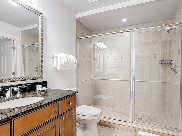 1356 Centre Court Ridge Dr Unit 103, Reunion, FL 34747 - bathroom featuring a shower stall, tile patterned flooring, vanity, and toilet