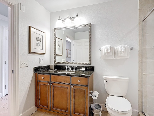 1356 Centre Court Ridge Dr Unit 103, Reunion, FL 34747 - bathroom featuring vanity, baseboards, a tile shower, toilet, and tile patterned flooring