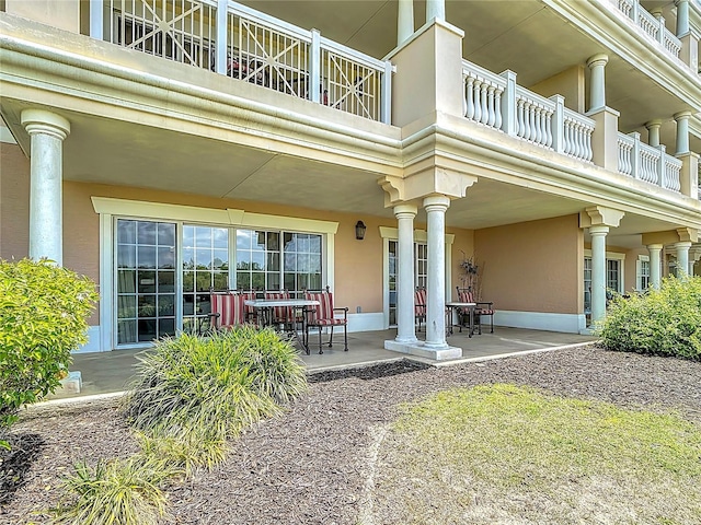 1356 Centre Court Ridge Dr Unit 103, Reunion, FL 34747 - entrance to property featuring a patio area, a balcony, and stucco siding