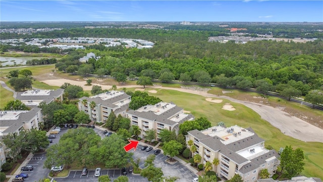 1356 Centre Court Ridge Dr Unit 103, Reunion, FL 34747 - drone / aerial view featuring view of golf course and a wooded view