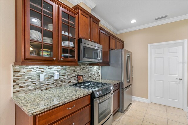 kitchen featuring stainless steel appliances, visible vents, light tile patterned flooring, light stone countertops, and decorative backsplash