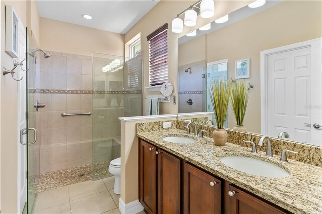 full bath featuring a sink, a shower stall, and toilet