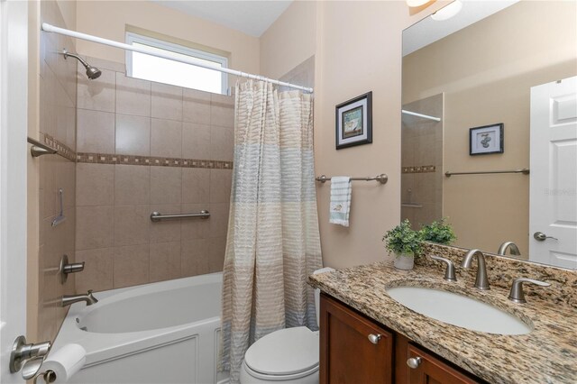 bathroom with toilet, vanity, and shower / bath combination with curtain