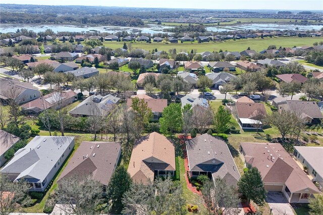 drone / aerial view with a water view and a residential view
