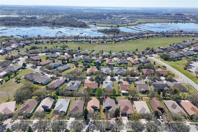 drone / aerial view featuring a water view and a residential view