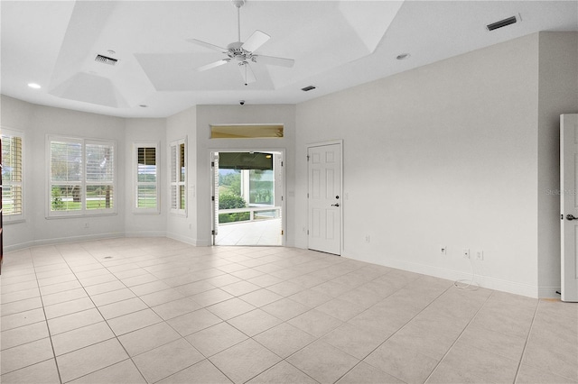 1721 Sunset Ridge Dr, The Villages, FL 32162 - empty room with a tray ceiling, light tile patterned flooring, a ceiling fan, recessed lighting, and baseboards