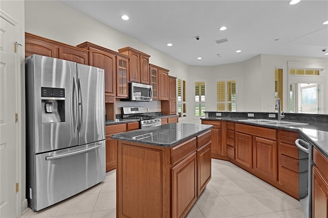1721 Sunset Ridge Dr, The Villages, FL 32162 - kitchen featuring stainless steel appliances, a sink, light tile patterned flooring, recessed lighting, and brown cabinets