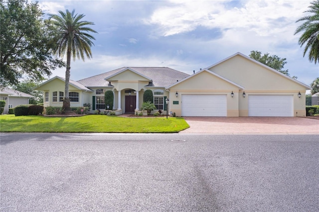 1721 Sunset Ridge Dr, The Villages, FL 32162 - ranch-style house featuring stucco siding, driveway, a front yard, and an attached garage