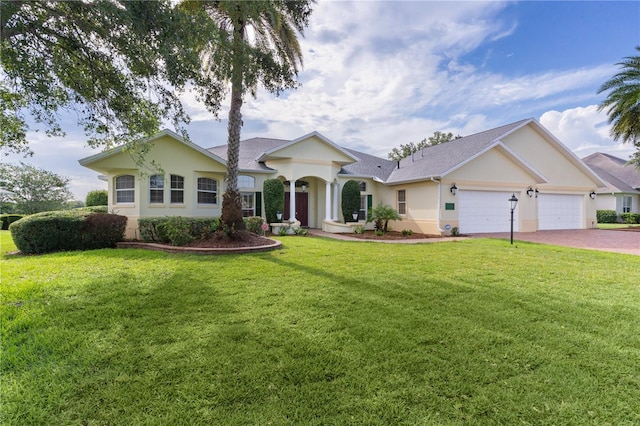 1721 Sunset Ridge Dr, The Villages, FL 32162 - single story home featuring stucco siding, an attached garage, driveway, a front lawn, and roof with shingles