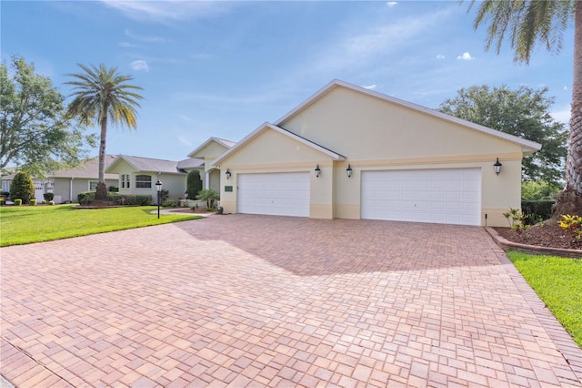 1721 Sunset Ridge Dr, The Villages, FL 32162 - ranch-style home with decorative driveway, stucco siding, an attached garage, and a front yard