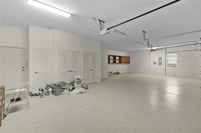 1721 Sunset Ridge Dr, The Villages, FL 32162 - garage featuring electric panel and a garage door opener