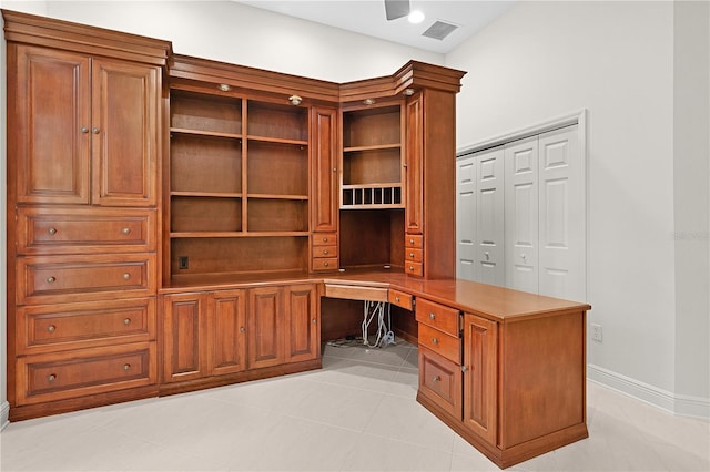 1721 Sunset Ridge Dr, The Villages, FL 32162 - unfurnished office featuring built in desk, light tile patterned flooring, and baseboards