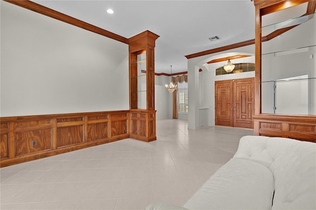 1721 Sunset Ridge Dr, The Villages, FL 32162 - foyer entrance featuring a chandelier, crown molding, light tile patterned floors, wainscoting, and recessed lighting