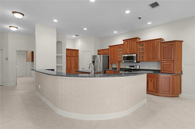 1721 Sunset Ridge Dr, The Villages, FL 32162 - kitchen featuring appliances with stainless steel finishes, brown cabinetry, baseboards, recessed lighting, and backsplash