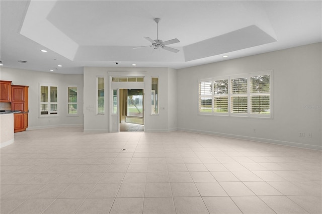 1721 Sunset Ridge Dr, The Villages, FL 32162 - unfurnished living room with a raised ceiling, ceiling fan, baseboards, recessed lighting, and light tile patterned flooring