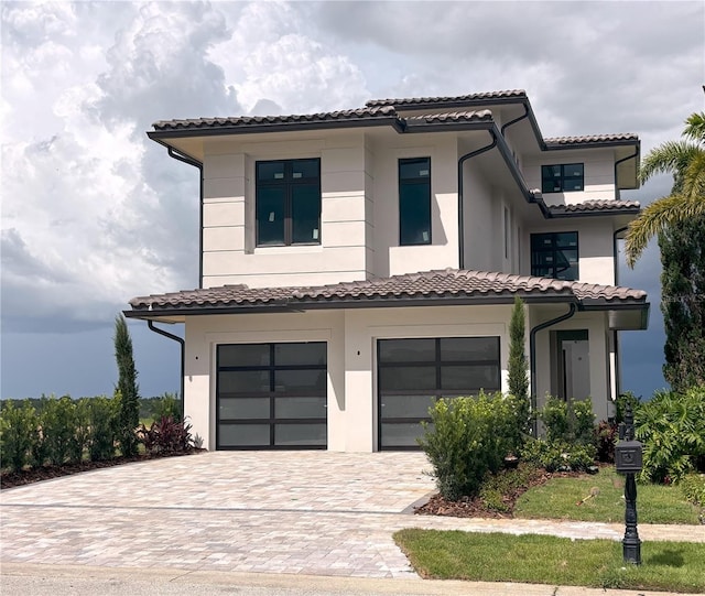 16142 Trivoli Cir, Bella Collina, FL 34756 - view of front of house with a garage, decorative driveway, a tile roof, and stucco siding