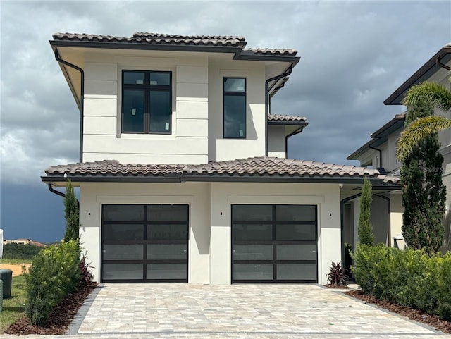16142 Trivoli Cir, Bella Collina, FL 34756 - view of front of property featuring a garage, decorative driveway, stucco siding, and a tiled roof
