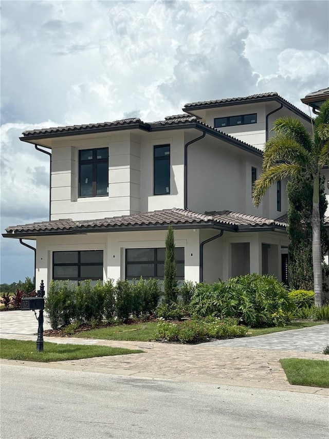 16142 Trivoli Cir, Bella Collina, FL 34756 - view of front of house featuring a tiled roof, stucco siding, and driveway