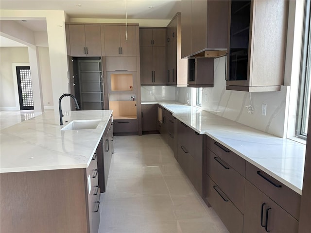 16142 Trivoli Cir, Bella Collina, FL 34756 - kitchen featuring a large island, light stone counters, and modern cabinets