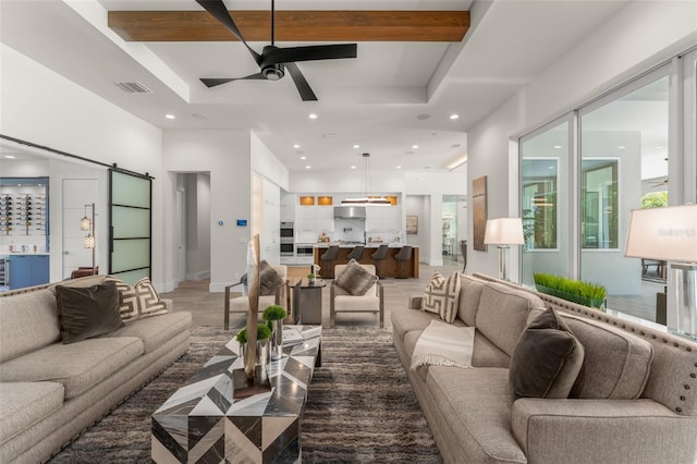 living room featuring a barn door, visible vents, ceiling fan, and recessed lighting