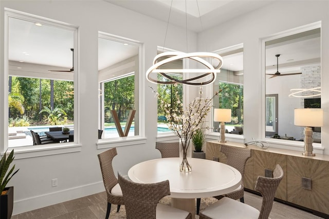 dining area featuring baseboards and a ceiling fan