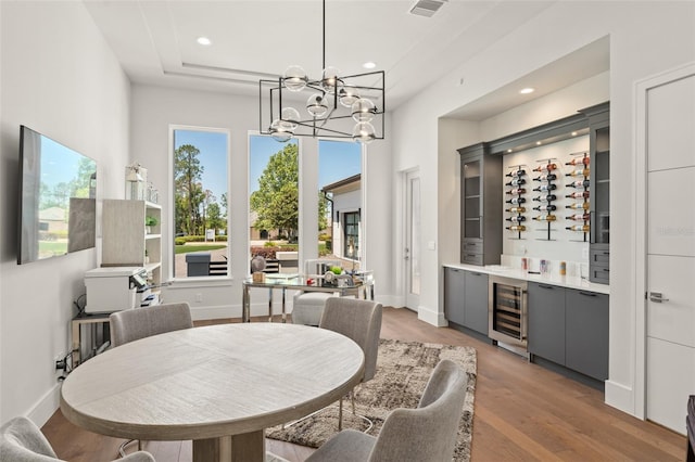 dining area with visible vents, a chandelier, light wood-type flooring, recessed lighting, and wine cooler