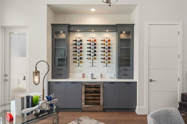 bar featuring a dry bar, wood finished floors, wine cooler, and recessed lighting