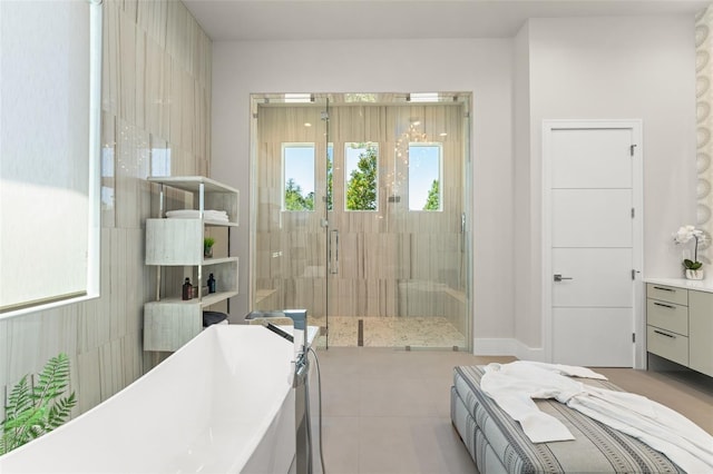 full bathroom with tile patterned floors, a freestanding bath, and a shower stall