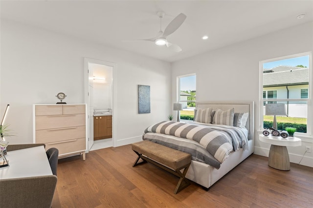 bedroom with recessed lighting, wood finished floors, ensuite bath, baseboards, and a ceiling fan