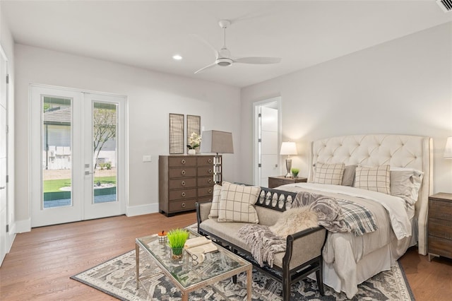 bedroom with recessed lighting, wood finished floors, access to exterior, baseboards, and french doors