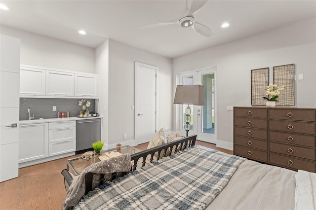 bedroom with recessed lighting, indoor wet bar, a sink, ceiling fan, and light wood-style flooring