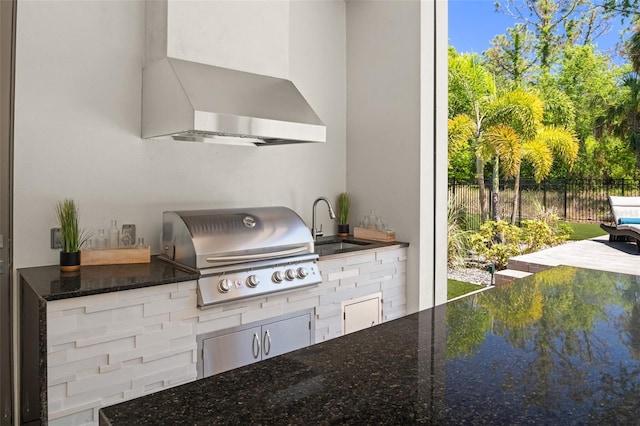 view of patio featuring a grill, an outdoor kitchen, fence, and a sink