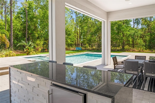 view of swimming pool featuring a fenced in pool, a patio, an in ground hot tub, and a fenced backyard