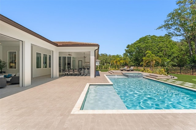 view of pool with a patio, a pool with connected hot tub, an outdoor living space, ceiling fan, and fence