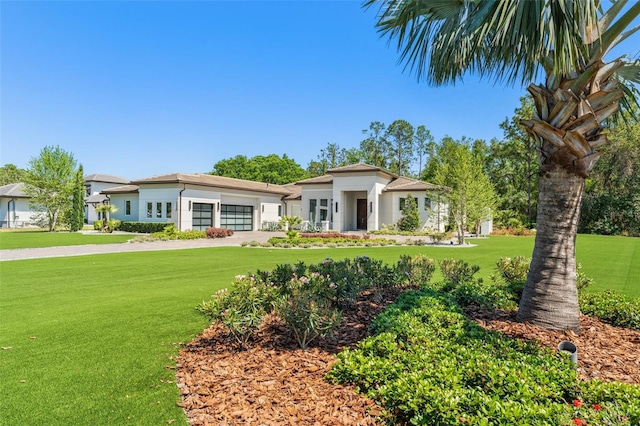 view of front of house with driveway, a front lawn, and a garage