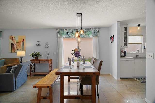 dining room with light tile patterned floors and a textured ceiling