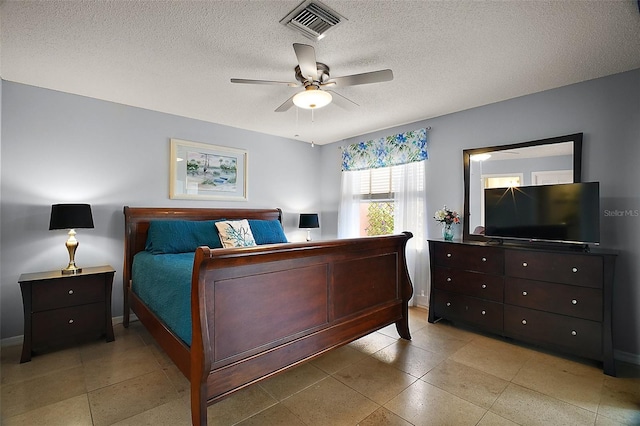 bedroom featuring a textured ceiling, visible vents, a ceiling fan, and baseboards