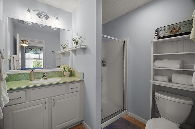 full bath featuring wood finished floors, a shower stall, toilet, vanity, and baseboards