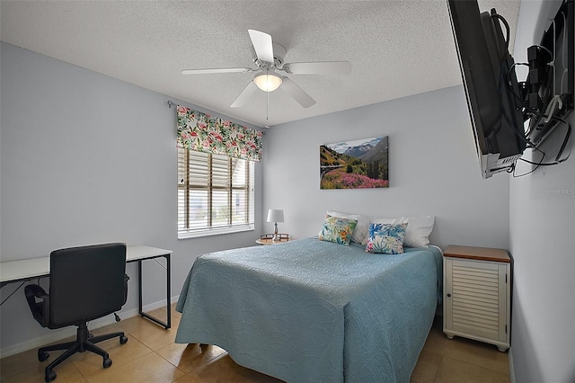 bedroom with a textured ceiling, ceiling fan, tile patterned flooring, and baseboards