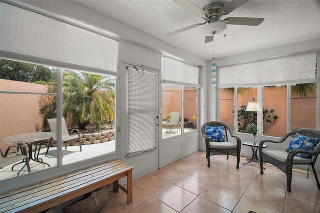 sunroom / solarium featuring a wealth of natural light and ceiling fan