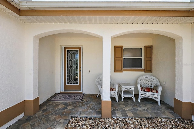 entrance to property with stucco siding